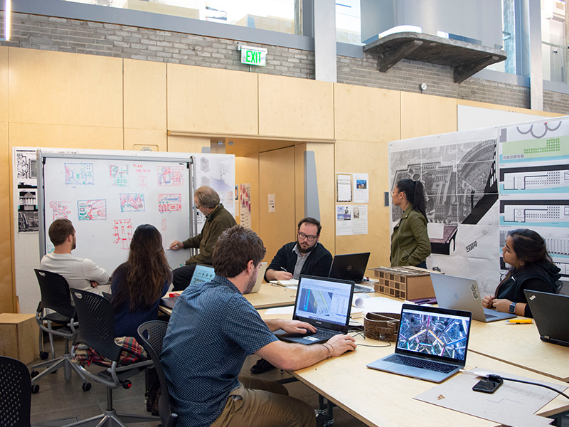 Associate professor, Michael Gamble, works with students during his Fall 2018 studio in the Hinman Research Building.