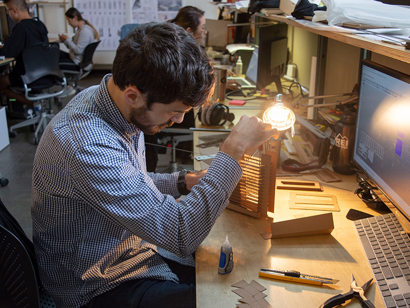 M.Arch Student, Alex Knight, observes how light passes through his model for Keith Kaseman's Fall 2018 studio.