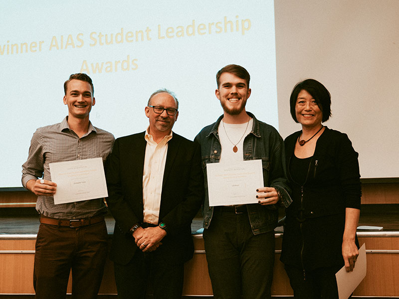 Students Chris Tromp and Colt Brock accepting their American Institute of Architecture Students Leadership Award at the 2019 Awards Day program in the Reinsch-Pierce Family Auditorium.