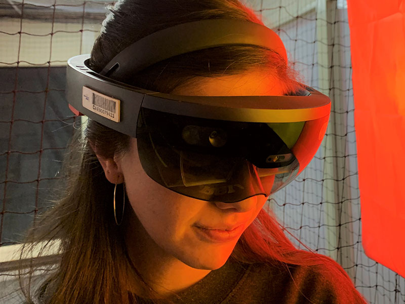 Graduate Assistant for Keith Kaseman's Spatial Futures Lab, Dani Marquez, wearing a Microsoft Hololens for the droneport project in the Digital Fabrication Lab. 