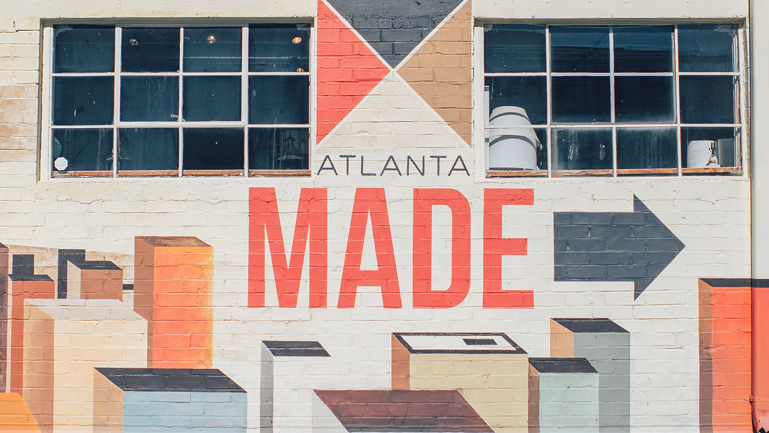 Building mural with a cityscape and the text Atlanta Made. Photo by Ian Schneider on Unsplash.