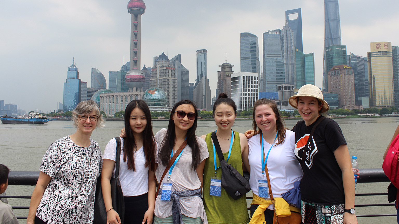 Michelle Rinehart and first-year students in front of the Shanghai skyline.