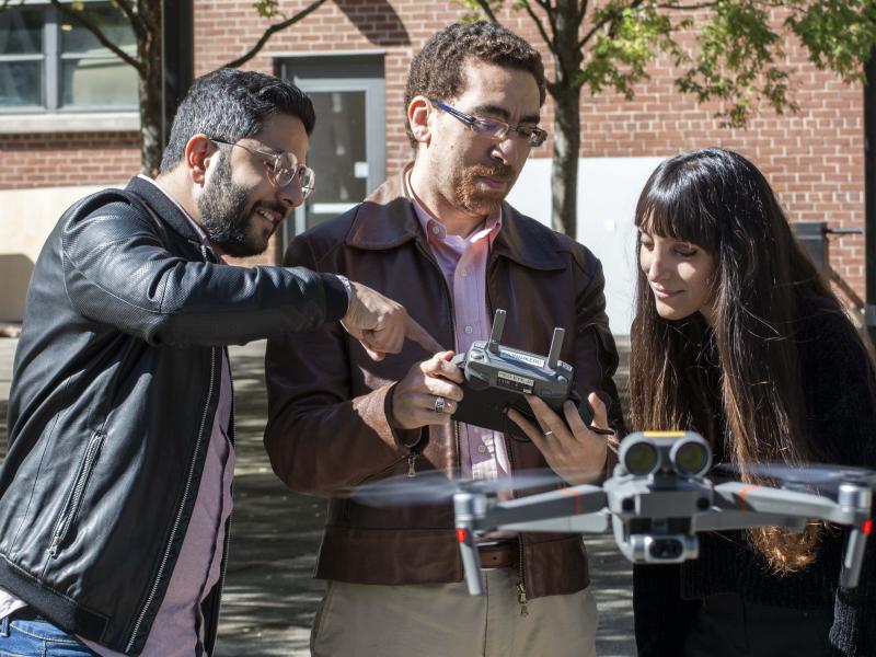 High Performance Building Lab director, Tarek Rakha, and students with a drone in the Hinman Courtyard.