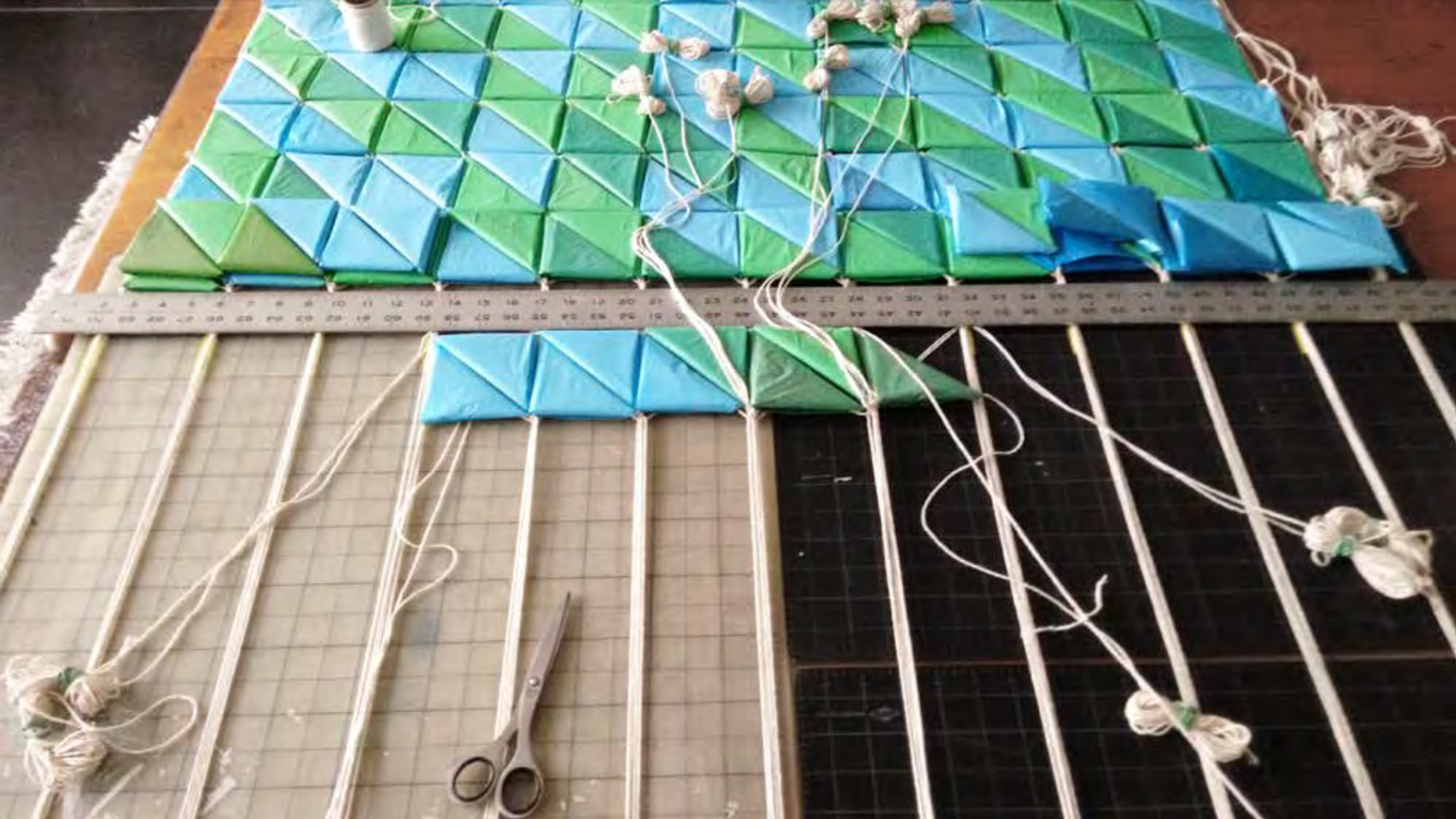 Tapestry formed of disposable plastic shopping bags and cotton twine, under construction